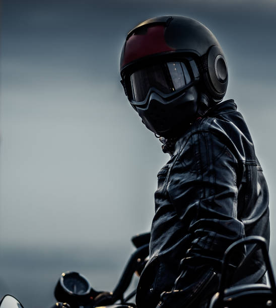 portrait of a biker wearing dark leather and helmet